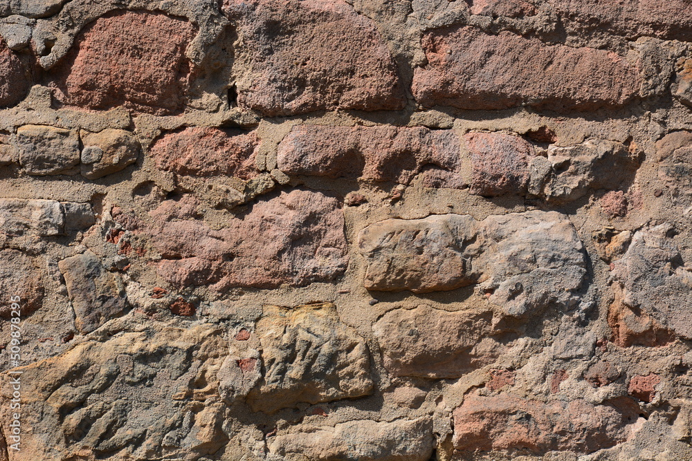 Wall made of reddish stones of irregular form Wall made of reddish stones of irregular form
