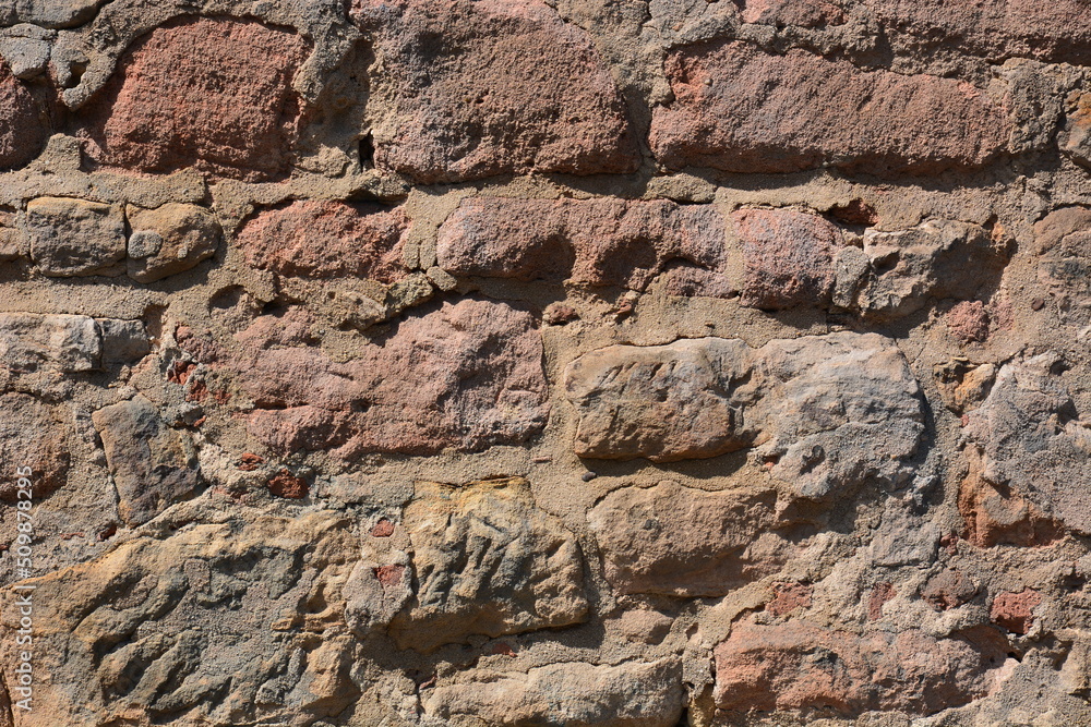 Wall made of reddish stones of irregular form