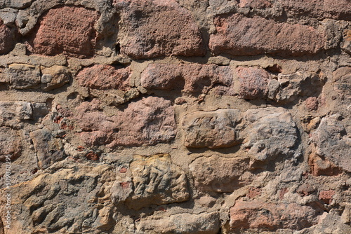 Wall made of reddish stones of irregular form