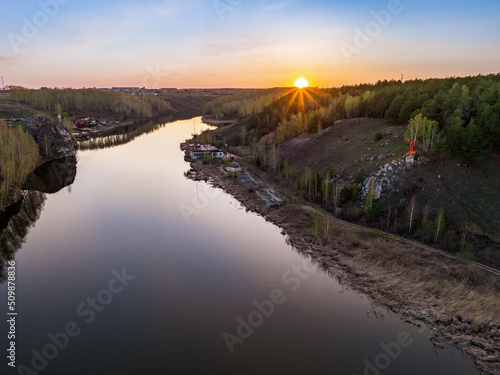 Beauriful sunset view along the Iset river and rocks near Kamensk-Uralskiy. A scenic sunset at the river. Kamensk-Uralskiy  Sverdlovsk region  Ural mountains  Russia. Aerial view
