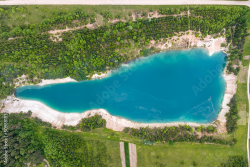 ariel top view of an old flooded lime quarry with turquoise water