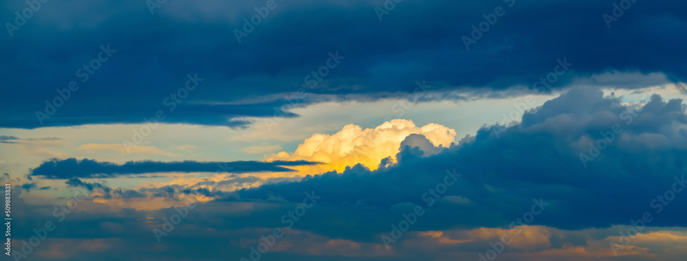 Blue sky background with dramatic cumulus blue and silver clouds. Panorama, copy space, poster. Picture for weather forecast.