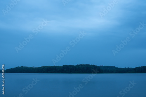 Beautiful evening nearby the lake with blue clouds