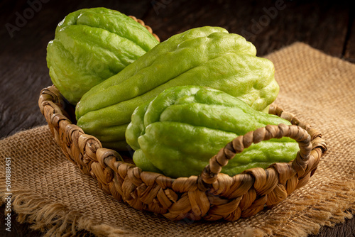 Fresh chayote fruits on the table. photo