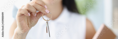 Agent or realtor holding key to new landlord or tenant or rental photo