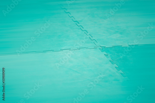 Karate tatami turquoise. Background for sports martial arts with motion blur.