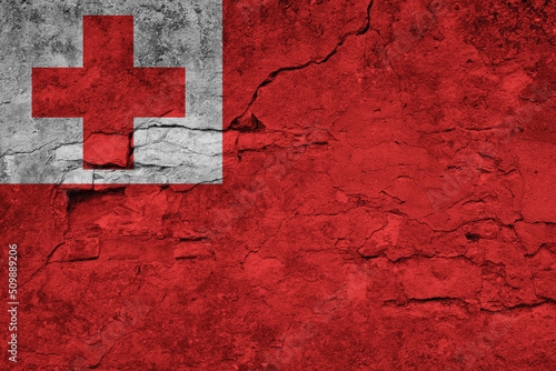 Patriotic cracked wall background in colors of national flag. Tonga