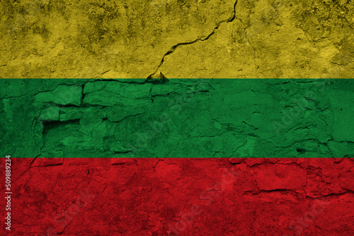 Patriotic cracked wall background in colors of national flag. Lithuania
