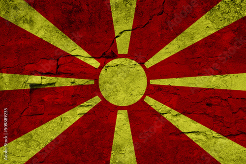 Patriotic cracked wall background in colors of national flag. Macedonia