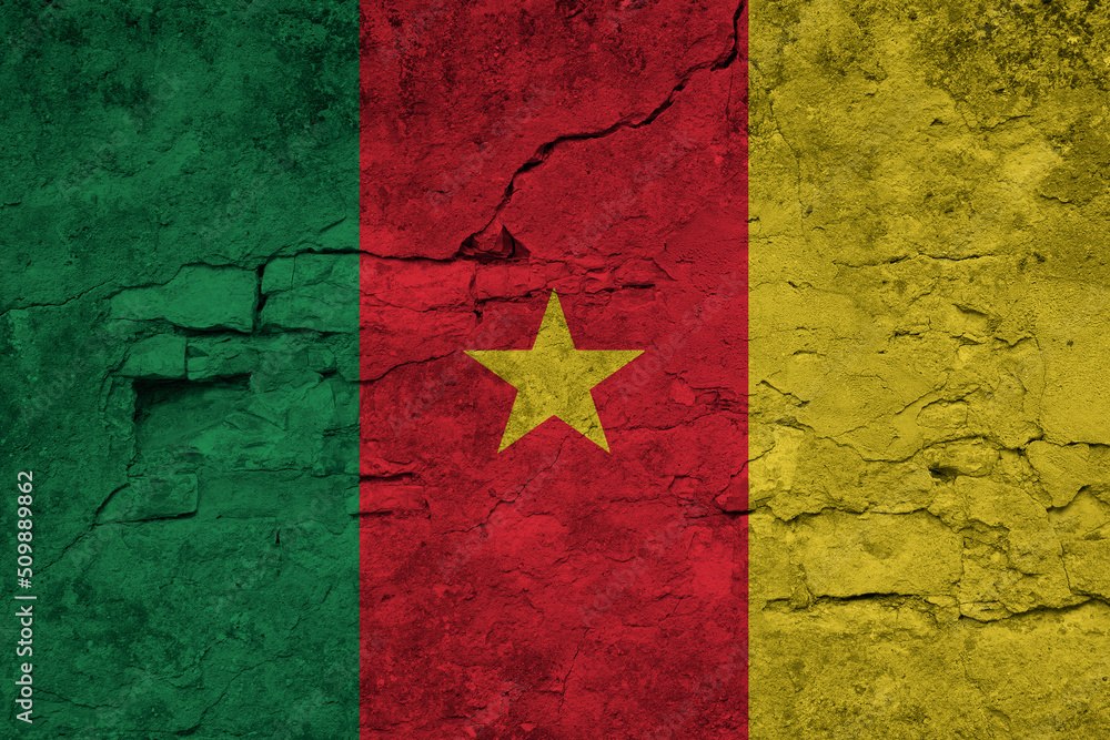 Patriotic cracked wall background in colors of national flag. Cameroon