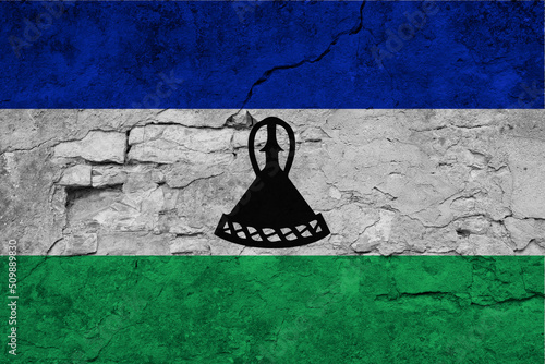 Patriotic cracked wall background in colors of national flag. Lesotho