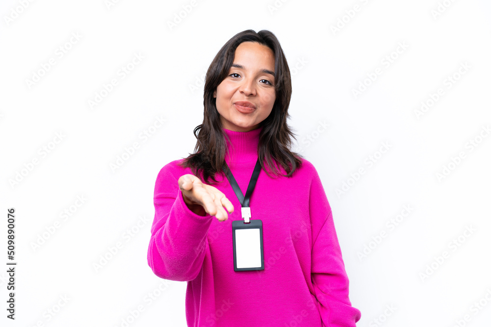 Young hispanic woman with ID card isolated on white background shaking hands for closing a good deal Young hispanic woman with ID card isolated on white background shaking hands for closing a good deal