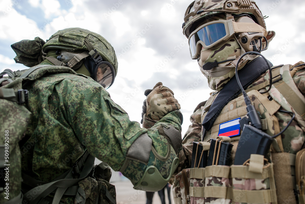 Handshake of two Russian military soldiers against the sky Handshake of two Russian military soldiers against the sky