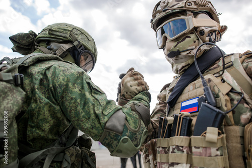 Handshake of two Russian military soldiers against the sky photo