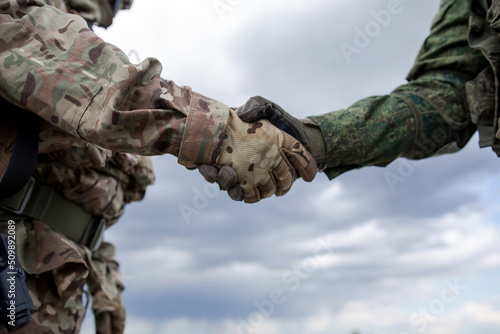 Print op canvas Handshake of two military soldiers