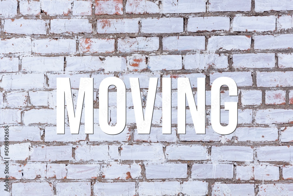 MOVING - word on concrete background. Cement floor, wall. MOVING - word on concrete background. Cement floor, wall.