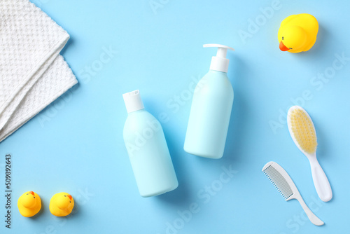 Baby bathing cosmetics and accessories on blue background. Flat lay. Top view.