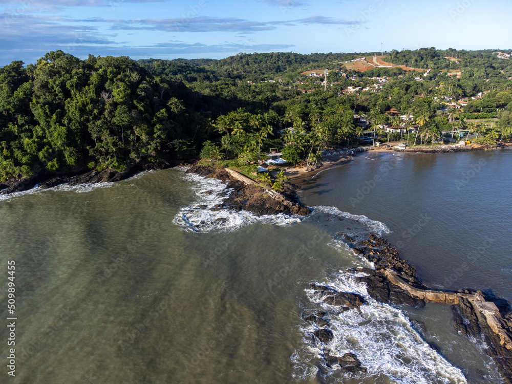Aerial drone view of rocks separating the sea from the river in a coastal city
