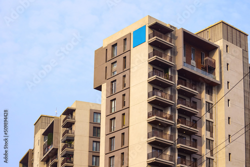 Beautiful modern residential or commercial apartment flat building exterior. Fragment of New luxury house and home flat complex. Part of City Real estate property and architecture including blue sky.