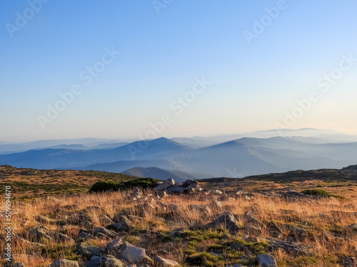 Mountain landscape at Torre  Serra da Estrela  Portugal. View of the golden vegetation field  mountain chain and widmills