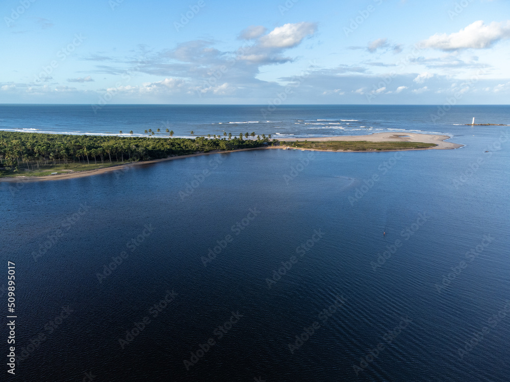 Sandbar separating river and sea in the midst of nature - Itacaré, Bahia, Brazil Sandbar separating river and sea in the midst of nature - Itacaré, Bahia, Brazil