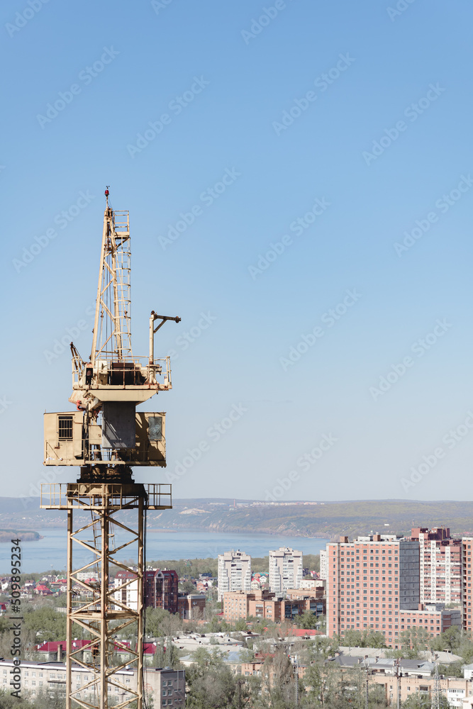 crane at construction site panorama of city. unfinished building, building under construction. panorama of city, construction of high-rise building russia