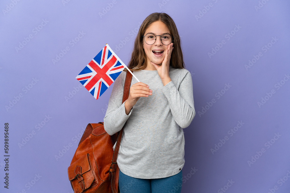 Child holding an United Kingdom flag over isolated background with surprise and shocked facial expression Child holding an United Kingdom flag over isolated background with surprise and shocked facial expression