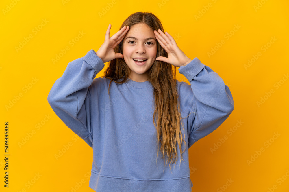 Child over isolated yellow background with surprise expression Child over isolated yellow background with surprise expression
