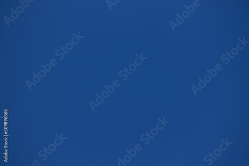 Background, section of a cloudless sky of royal blue color.