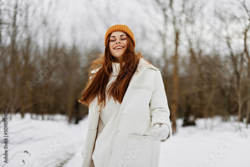 cheerful woman red hair walk in the fresh winter air Walk in the winter forest