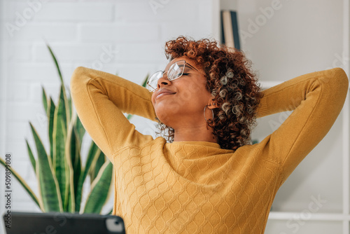 Fotografie african american woman with laptop relaxing at home