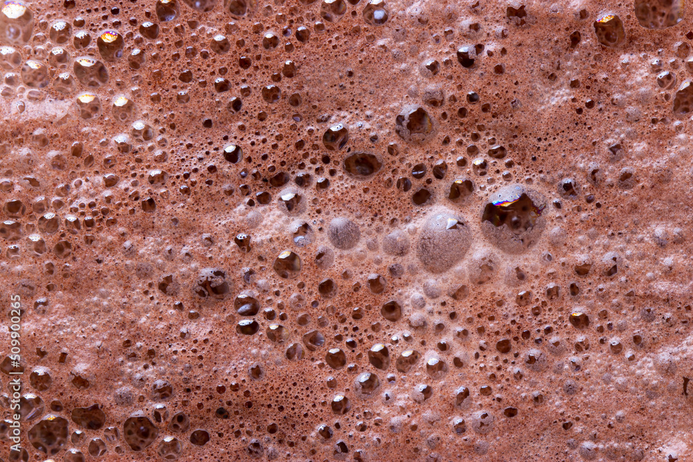 Chocolate milk texture in glass cup with small bubbles Chocolate milk texture in glass cup with small bubbles