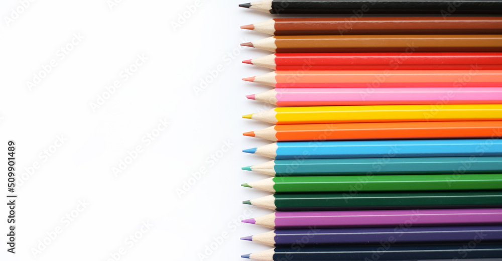 A set of colored pencils isolated on a white background in banner format. Place for text A set of colored pencils isolated on a white background in banner format. Place for text