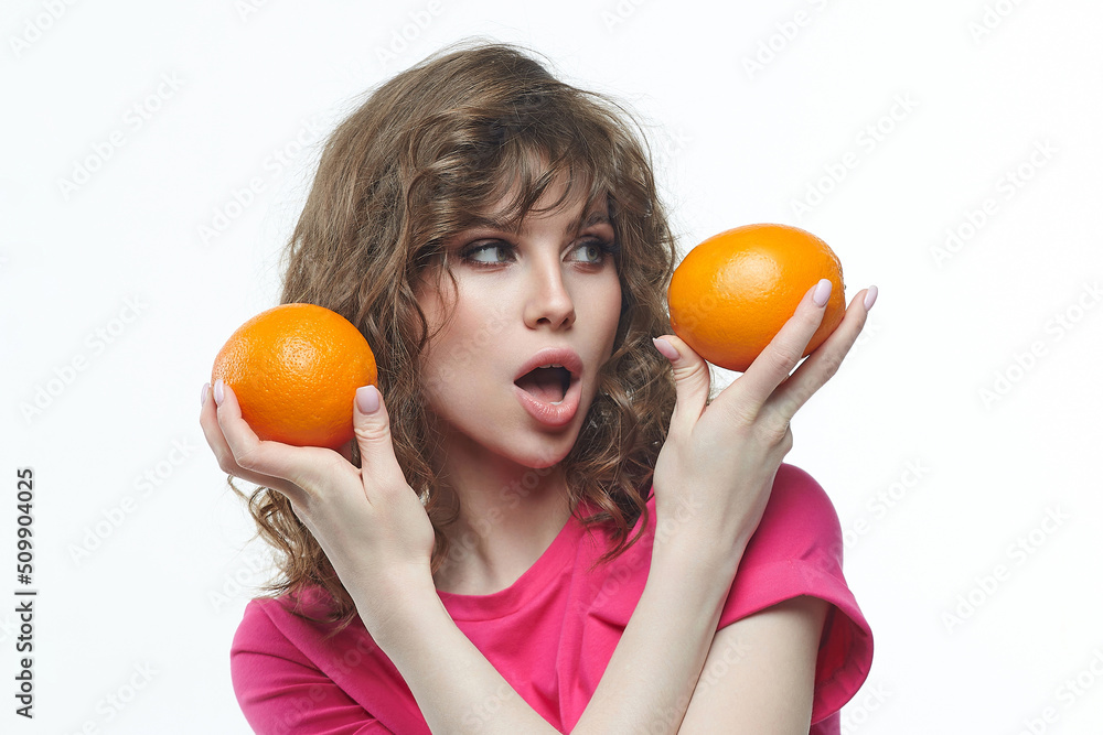 attractive girl with oranges in her hands photo shoot in the studio on a white background attractive girl with oranges in her hands photo shoot in the studio on a white background