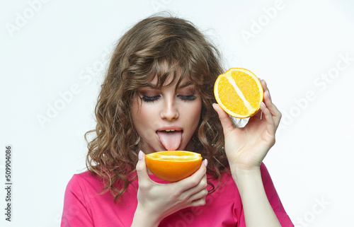 attractive girl with oranges in her hands photo shoot in the studio on a white background