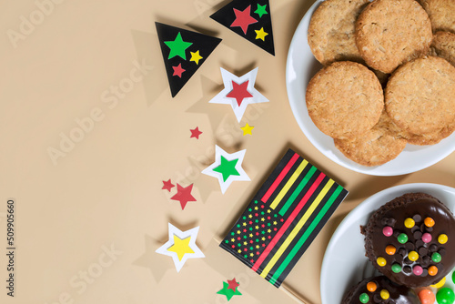 creative background for Juneteenth day with Black Liberation African American flags, tea cakes cookie and bright flowers