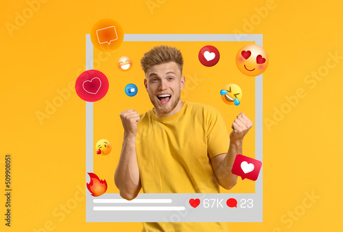 Happy young male blogger on yellow background photo