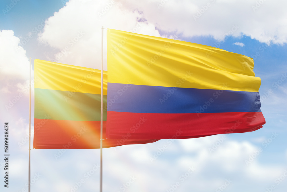 Sunny blue sky and flags of colombia and lithuania Sunny blue sky and flags of colombia and lithuania