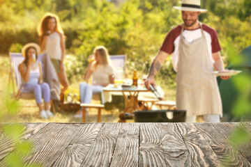 Empty wooden table at barbecue party outdoors