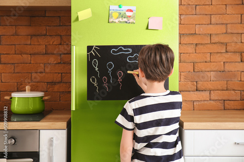 Little boy drawing on chalk...