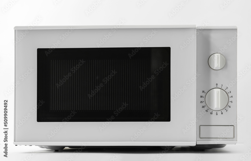New modern microwave oven on light background New modern microwave oven on light background