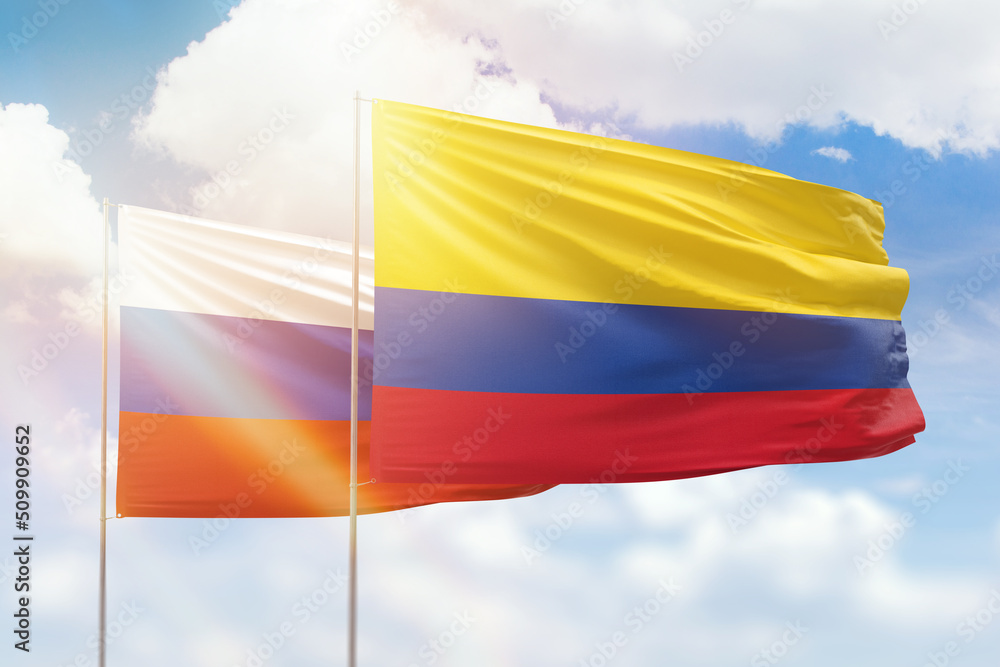 Sunny blue sky and flags of colombia and russia Sunny blue sky and flags of colombia and russia