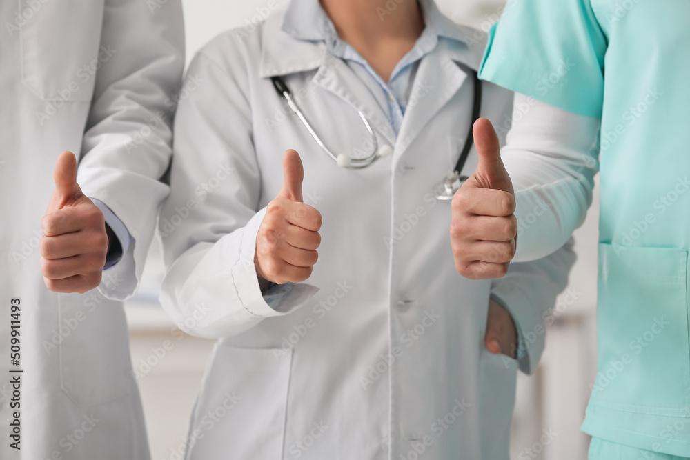 Group of doctors showing thumb-up in clinic Group of doctors showing thumb-up in clinic
