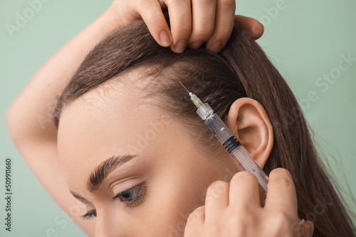 Young woman with hair loss ...