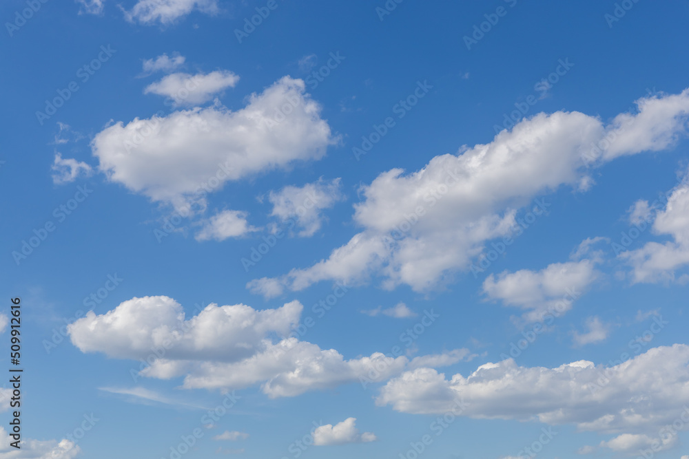 Bright blue sky with light clouds. Calm texture or background Bright blue sky with light clouds. Calm texture or background