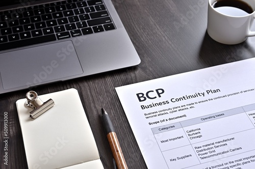 There is dummy documents that created for the photo shoot on the desk about Business Continuity Plan.
