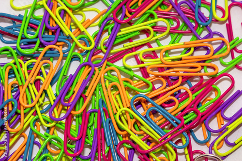 Large pile of metal colorful paperclips