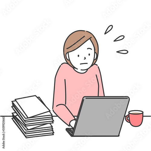 仕事が溜まり焦ってパソコンを使用する女性