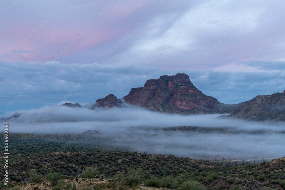 Photograph of Red Mountain in Arizona in the fog. 