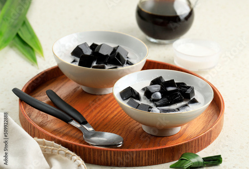 Es Cincau Hitam or Black Grass Jelly, Indonesian Dessert Made from Cincau Leaf with Coconut Milk and Palm Sugar. photo